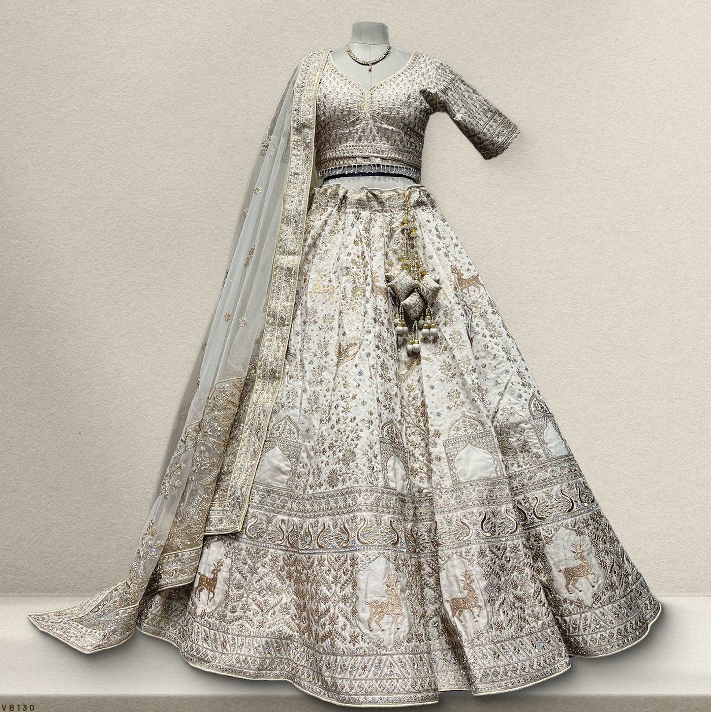 Elegant ivory bridal lehenga with intricate embroidery and matching choli from JMS Studio