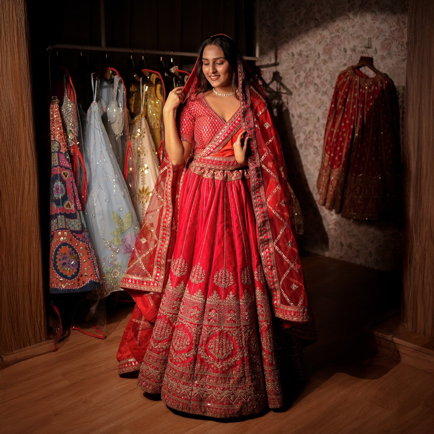 Elegant woman in a vibrant setting wearing a beautiful saree, showcasing designer red lehenga online