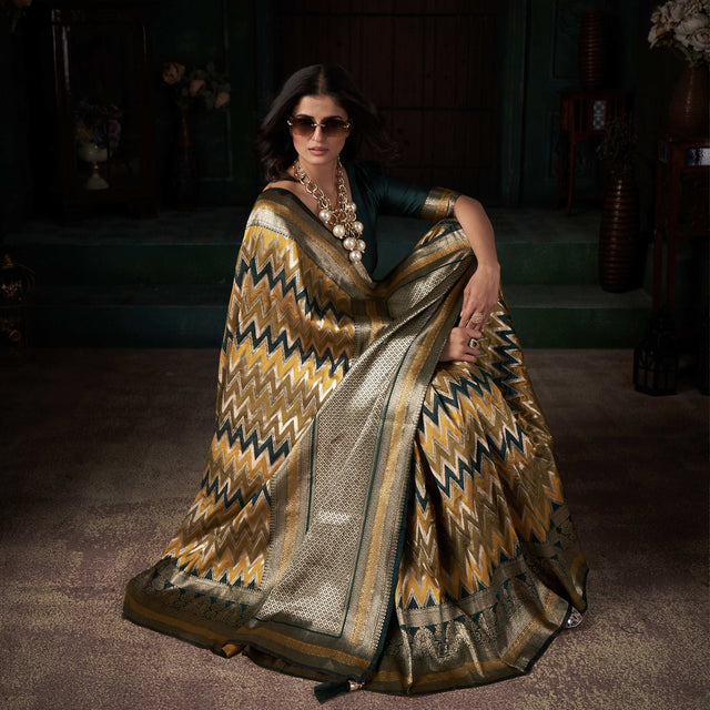 Gold-toned silk saree with zigzag chevron pattern and silver border, draped on model