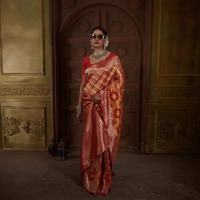 Red and gold zari woven Kanjivaram silk saree with patterned pallu and border