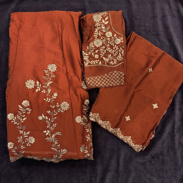 Rust lehenga choli set with gold thread embroidery and sequins, plus matching dupatta