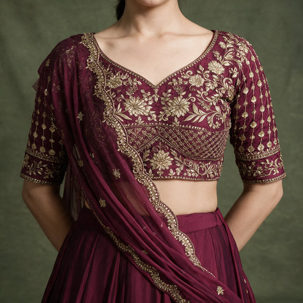 Close-up of the wine blouse with gold embroidery and the scalloped-edge dupatta draped across the shoulder