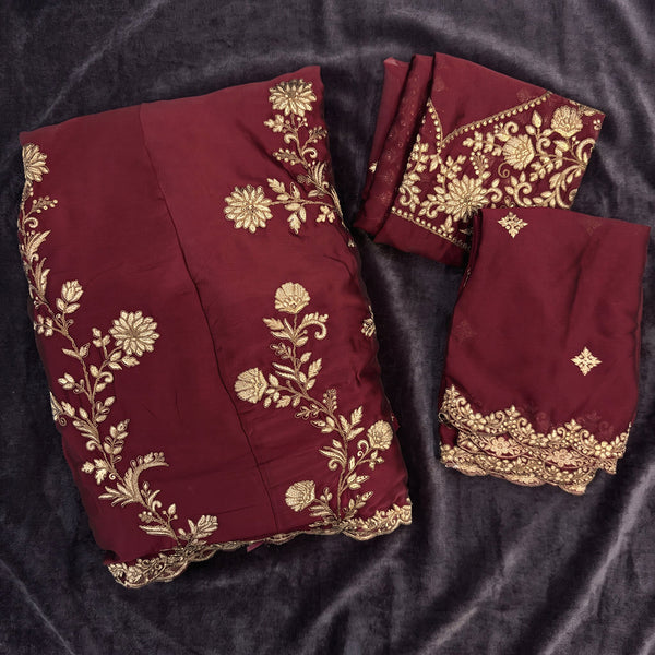 Flat lay of the wine rangoli silk lehenga with gold floral embroidery, the embroidered blouse and the scalloped dupatta