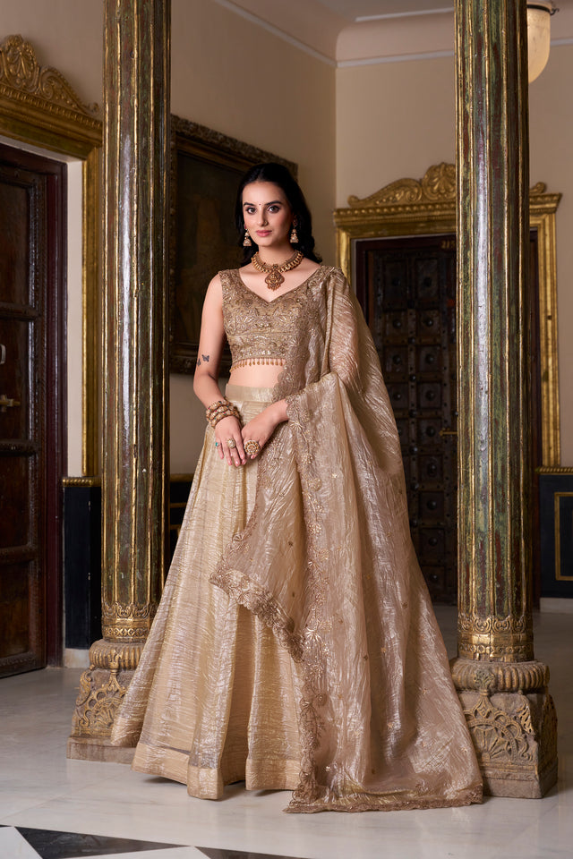 Beige sequined lehenga choli set with thread embroidery and ornate neckline, standing front