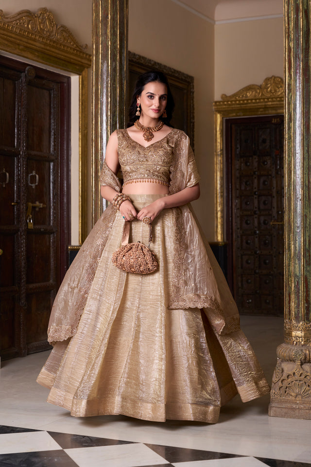 Beige sequined lehenga choli set with embroidered bodice and flared skirt, side pose