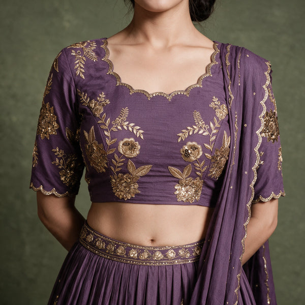 Doli lavender embroidered blouse with scalloped neckline, gold zari floral work and pleated skirt waistband