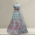 Embroidered light blue lehenga with pink floral motifs and sheer matching dupatta