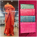 Art silk Banarsi saree on mannequin in orange-red with golden border and diamond motifs