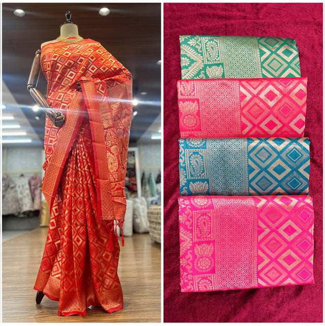 Art silk Banarsi saree on mannequin in orange-red with golden border and diamond motifs