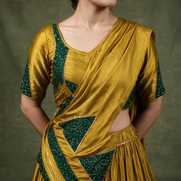 Close-up of the mustard blouse with green printed triangles on the sleeves and the dupatta draped across the shoulder
