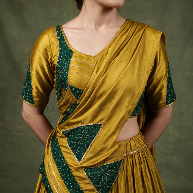 Close-up of the mustard blouse with green printed triangles on the sleeves and the dupatta draped across the shoulder