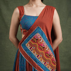 Close-up of the blue printed blouse and the rust dupatta with a gamthi panel and lace edge