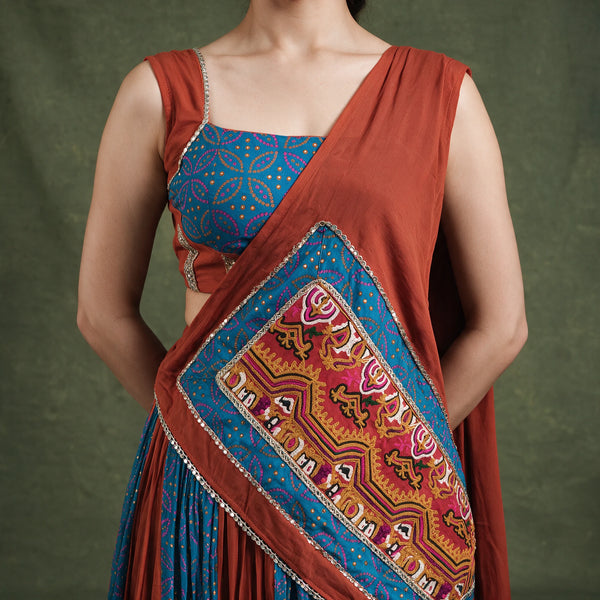 Close-up of the blue printed blouse and the rust dupatta with a gamthi panel and lace edge