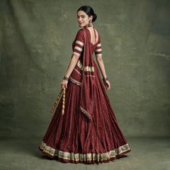 Back view of the maroon chaniya choli with open-back blouse, draped dupatta and gold lace hem border