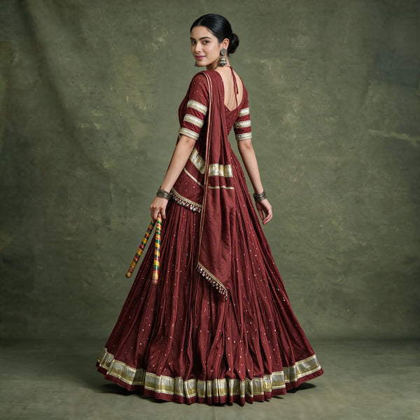 Back view of the maroon chaniya choli with open-back blouse, draped dupatta and gold lace hem border