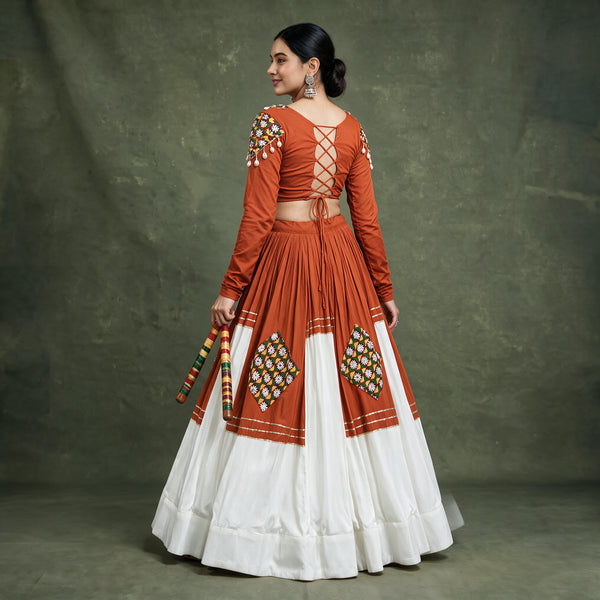 Back view of the orange blouse with a tie-up back and the orange and white skirt with patchwork diamonds