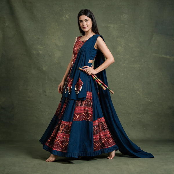 Side-back view of the navy and red chaniya choli in a twirl with the dupatta trailing behind
