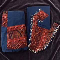 Flat lay of the navy skirt with a red printed panel and the navy dupatta with cowrie-trimmed red panels