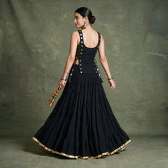 Back view of the black koti and tiered skirt with a gold hem border