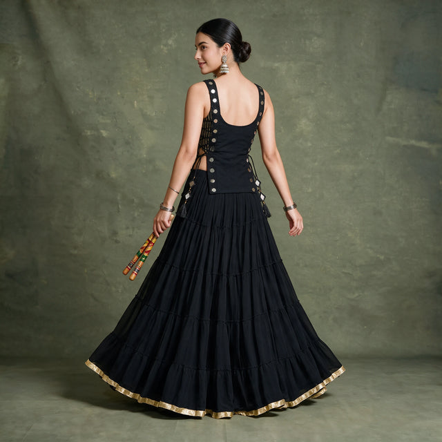 Back view of the black koti and tiered skirt with a gold hem border