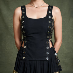 Close-up of the black sleeveless koti with round silver discs down both sides and side tie-ups