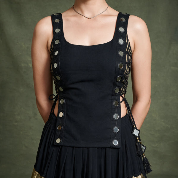 Close-up of the black sleeveless koti with round silver discs down both sides and side tie-ups