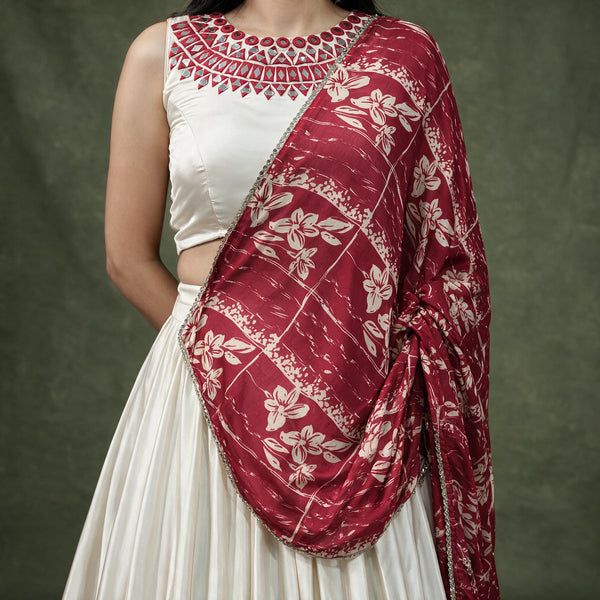 Close-up of the ivory blouse with embroidered neckline and the maroon floral printed satin chiffon dupatta