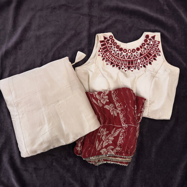 Flat lay of the ivory monga silk skirt and blouse with a maroon embroidered neckline and the maroon printed dupatta