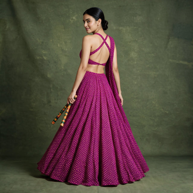 Back view of the magenta bandhej-print chaniya choli with criss-cross blouse back and a full flared skirt