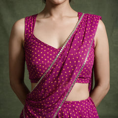 Close-up of the magenta bandhej-print blouse and the dupatta edged with mirror lace