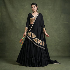 Model in a black khadi cotton chaniya choli with a black dupatta edged in cream lace with gold triangular patches, holding dandiya sticks