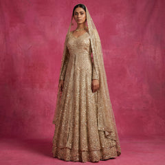Champagne embellished bridal lehenga gown with V-neck, long sleeves, and net dupatta