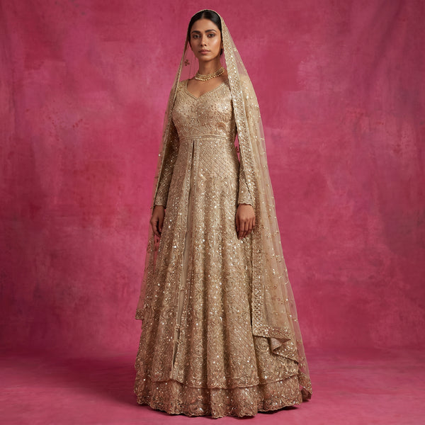Champagne embellished bridal lehenga gown with V-neck, long sleeves, and net dupatta