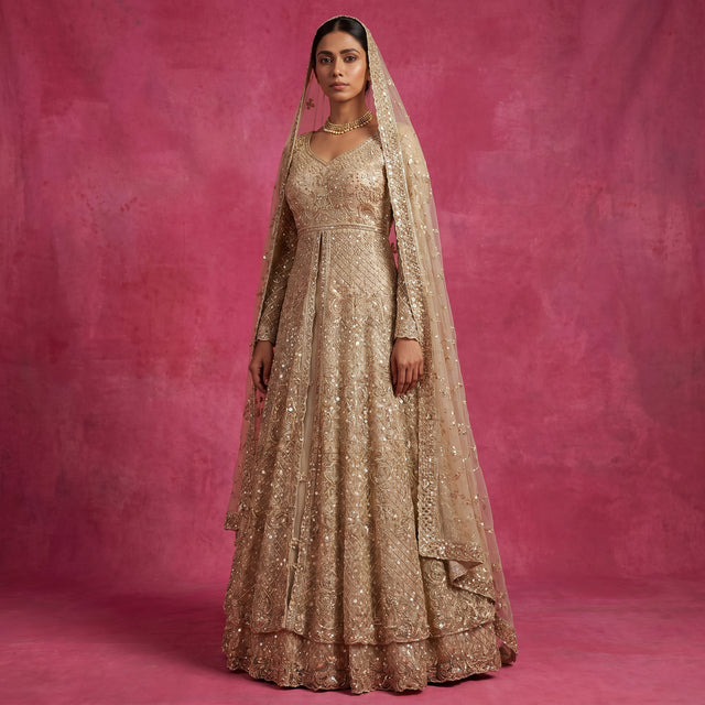 Champagne embellished bridal lehenga gown with V-neck, long sleeves, and net dupatta