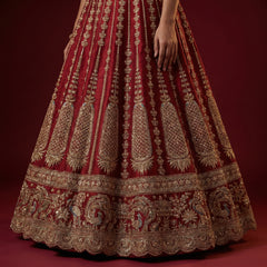 Maroon lehenga skirt with vertical gold kairi motifs and ornate embroidered hem