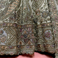 Embellished net lehenga skirt in golden ivory with zari and stone work, multicolor motifs