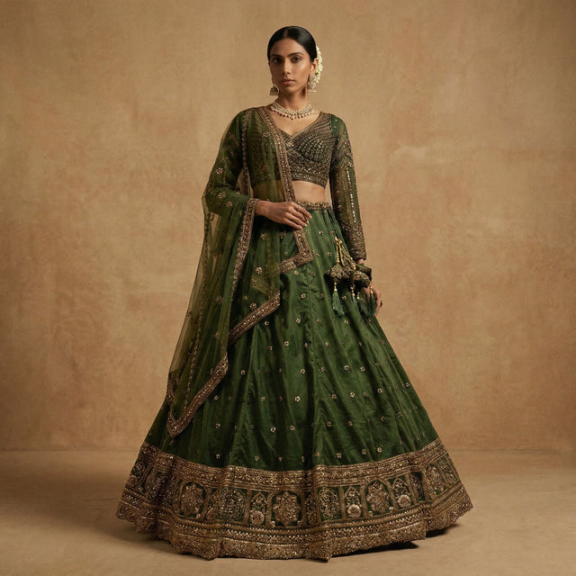 Bottle green lehenga set with matching embroidered dupatta and ornate gold hem