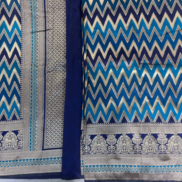Blue silk saree with zigzag chevron pattern and wide silver border with floral motifs