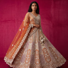 Women’s bridal lehenga in rust orange and ivory with ornate cutdana bodice and flare