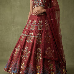 Maroon lehenga skirt with mirror-and-bead handwork, floral motifs, and border