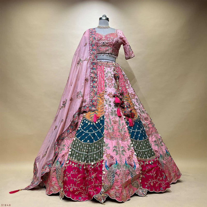 Pink lehenga outfit on mannequin: embroidered blouse, skirt, and long dupatta