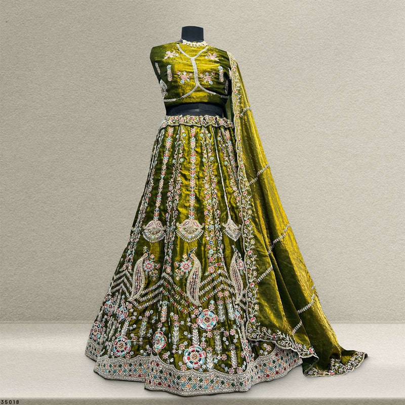 Olive embroidered lehenga on mannequin with embellished blouse and flared skirt