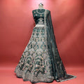 Bottle green organza lehenga with zari and resham floral jaal, embroidered flared skirt