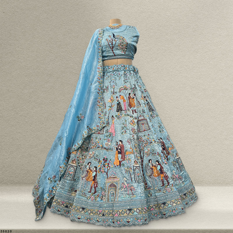Sky blue lehenga set, back view with embroidered blouse and full skirt, floral scenes