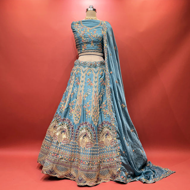 Teal blue lehenga with embroidered bodice-style yoke and flared skirt, zari trim