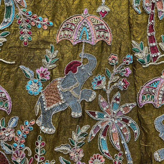 Embroidered green-gold fabric with colorful thread motifs and zari details