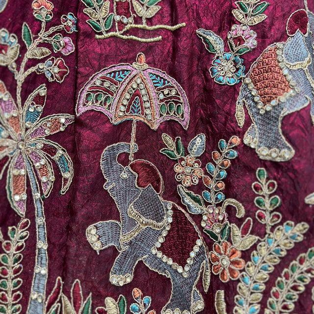 Maroon embroidered tissue silk fabric with gold, teal, and silver floral motifs