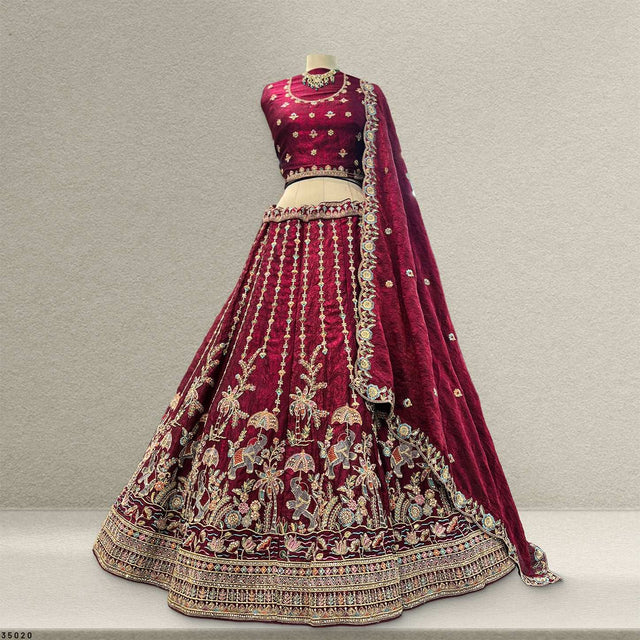 Maroon tissue silk lehenga with gold border and ornate floral embroidery on skirt