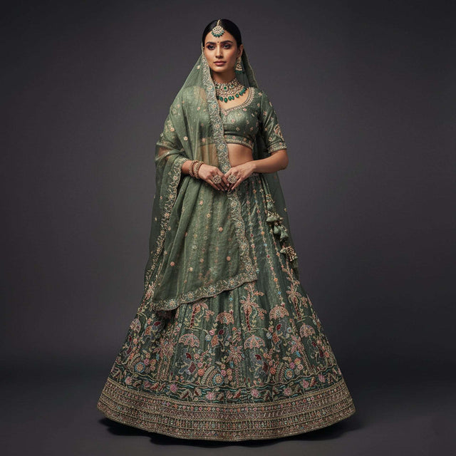 Olive green lehenga with gold zari border and multicolor floral embroidery, flared skirt
