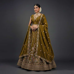 Golden-brown tissue silk lehenga with embroidered blouse and draped dupatta